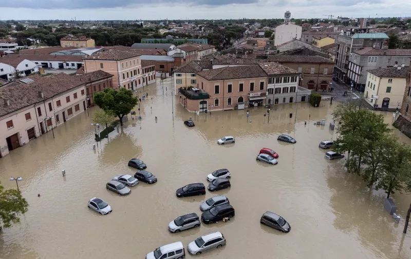 This aerial photograph shows flooded streets in the town of Lugo, near Ravenna, on May 18, 2023, after heavy rains caused flooding across Italy's northern Emilia Romagna region. Rescue workers searched on May 18, 2023 for people still trapped by floodwaters in northeast Italy as more residents were evacuated after downpours which killed nine people and devastated homes and farms. (Photo by Federico SCOPPA / AFP)