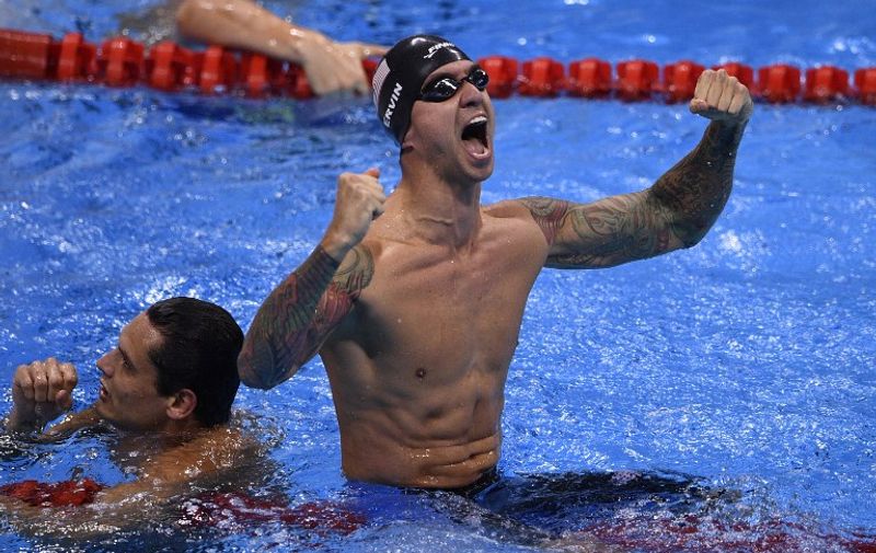 USA's Anthony Ervin (R) reacts next to second placed France's Florent Manaudou after he won the Men's 50m Freestyle Final during the swimming event at the Rio 2016 Olympic Games at the Olympic Aquatics Stadium in Rio de Janeiro on August 12, 2016.   / AFP PHOTO / Martin BUREAU
