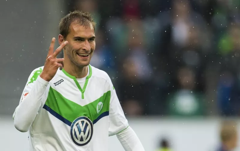 Wolfsburg's forward Bas Dost of the Netherlands (R) celebrates scoring a penalty kick to score his second goal of the day during the German first division Bundesliga football match VfL Wolfsburg vs Hertha BSC Berlin, in Wolfsburg, northern Germany on September 19, 2015.  AFP PHOTO / ODD ANDERSEN

RESTRICTIONS: DURING MATCH TIME: DFL RULES TO LIMIT THE ONLINE USAGE TO 15 PICTURES PER MATCH AND FORBID IMAGE SEQUENCES TO SIMULATE VIDEO. 
== RESTRICTED TO EDITORIAL USE ==  FOR FURTHER QUERIES PLEASE CONTACT DFL DIRECTLY AT + 49 69 650050. / AFP / ODD ANDERSEN