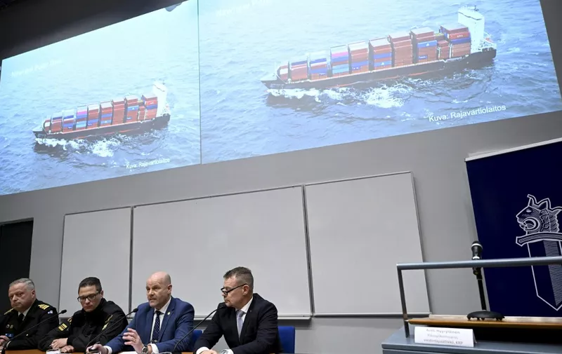 The commanding officer of the Finnish Navy Toni Joutsia (L to R), lieutenant commander of the Finnish Border Guard Markus Paljakka, the detective inspector of the National Bureau of Investigation Risto Lohi and the Chief of National Bureau of Investigation Robin Lardot attend a joint press conference of the investigation of the possible attack on the Balticconnector gas line on October 8, 2023 between Finland and Estonia at the headquarters of the National Bureau of Investigation in Vantaa, Finland on October 24, 2023. The screen shows Finnish Border Guard's photo of a Hong Kong -registered cargo ship 'Newnew Polar Bear', which was spotted moving close to the Balticconnector gas line.Finnish police said a Chinese ship was the focus of their investigation into suspected sabotage of the Balticconnector pipeline. (Photo by Heikki Saukkomaa / Lehtikuva / AFP) / Finland OUT