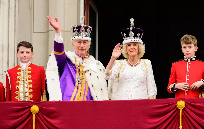 Britain's King Charles III and Britain's Queen Camilla and other members of the Royal Family wave to the crowds from the Buckingham Palace balcony as they wait for the Royal Air Force fly-past in central London on May 6, 2023, after their coronations. - The set-piece coronation is the first in Britain in 70 years, and only the second in history to be televised. Charles will be the 40th reigning monarch to be crowned at the central London church since King William I in 1066. Outside the UK, he is also king of 14 other Commonwealth countries, including Australia, Canada and New Zealand. Camilla, his second wife, was crowned Queen alongside him. (Photo by Leon Neal / POOL / AFP)