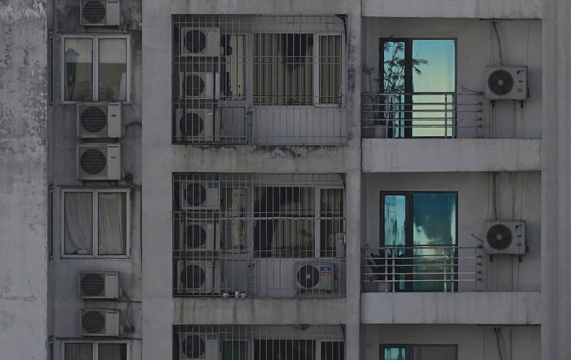 This photo taken on May 30, 2023 shows outdoor air conditioning units on a building in the centre of Hanoi. (Photo by Nhac NGUYEN / AFP)