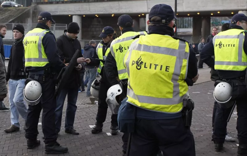 Police patrol the grounds outside the Amsterdam Arena stadium before the kick off of a UEFA Cup League match between Ajax Amsterdam and Manchester United, in Amsterdam, on February 16, 2012. AFP PHOTO/IAN KINGTON