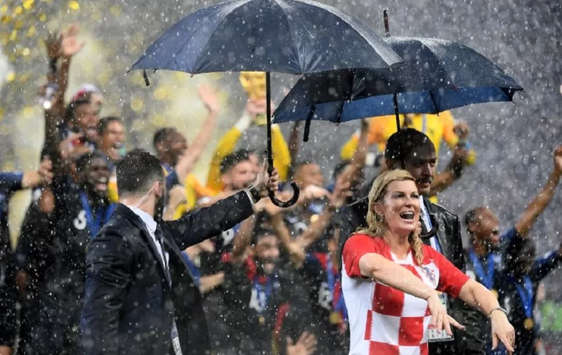 Croatian President Kolinda Grabar-Kitarovic (R) walks of the pitch after the Russia 2018 World Cup final football match between France and Croatia at the Luzhniki Stadium in Moscow on July 15, 2018. - France won the World Cup for the second time in their history after beating Croatia 4-2 in the final in Moscow's Luzhniki Stadium on Sunday. (Photo by Jewel SAMAD / AFP) / RESTRICTED TO EDITORIAL USE - NO MOBILE PUSH ALERTS/DOWNLOADS