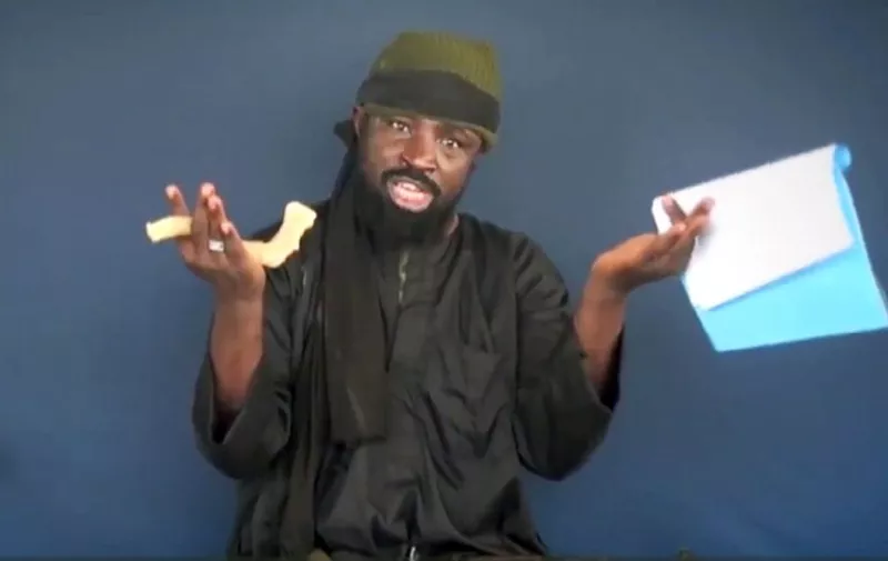 (FILES) This This screen grab image taken on February 18, 2015 from a video made available by Islamist group Boko Haram shows then Boko Haram leader Abubakar Shekau making a statement at an undisclosed location. 

In-fighting has broken out in Boko Haram after the Islamic State group announced a new leader of its Nigerian affiliate, according to reports in the country's remote northeast. IS said last month, August 2016, that Abu Musab al-Barnawi, the son of Boko Haram's founder Mohammed Yusuf, had replaced Abubakar Shekau at the head of the designated terrorist organisation. But Shekau then insisted he was still in charge of the Islamist group, whose insurgency has killed at least 20,000 people since 2009 and forced more than 2.6 million from their homes. / AFP PHOTO / BOKO HARAM / - / RESTRICTED TO EDITORIAL USE - MANDATORY CREDIT "AFP PHOTO / BOKO HARAM" - NO MARKETING NO ADVERTISING CAMPAIGNS - DISTRIBUTED AS A SERVICE TO CLIENTS