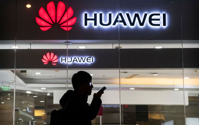 BEIJING, CHINA - JANUARY 29: A pedestrian talks on the phone while walking past a Huawei Technologies Co. store on January 29, 2019 in Beijing, China. The U.S. Justice Department filed a host of criminal charges against Chinese telecoms giant Huawei and its chief financial officer, Meng Wanzhou, including bank fraud, violating sanctions on Iran, and stealing robotic technology. Huawei denied committing any of the violations and rejected criminal claims against Meng, the daughter of Huawei founder Ren Zhengfei, who was arrested in Canada in December last year. (Photo by Kevin Frayer/Getty Images)