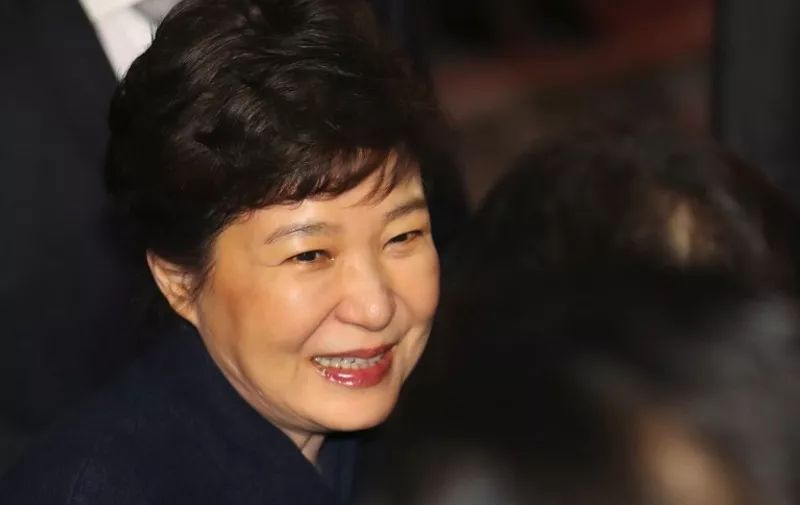 South Korea's impeached ex-president Park Geun-Hye (C) arrives at her private residence in Seoul on March 12, 2017. 
South Korea's impeached ex-president Park Geun-Hye left the presidential Blue House on March 12, two days after the Constitutional Court's verdict removing her from office over a massive corruption scandal.  / AFP PHOTO / YONHAP / STR /  - South Korea OUT / NO ARCHIVES -  RESTRICTED TO SUBSCRIPTION USE