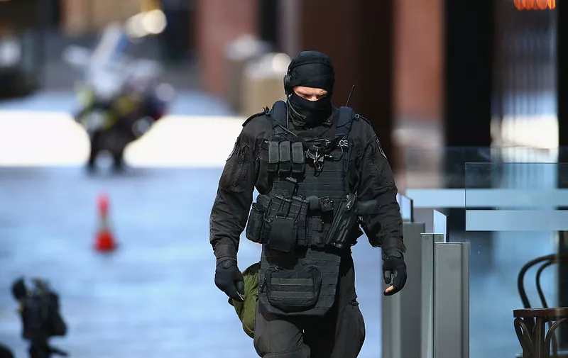 SYDNEY, AUSTRALIA - DECEMBER 15:  An armed policeman walks northward along Philip St , Martin Place on December 15, 2014 in Sydney, Australia.  Police attend a hostage situation at Lindt Cafe in Martin Place.  (Photo by Don Arnold/Getty Images)