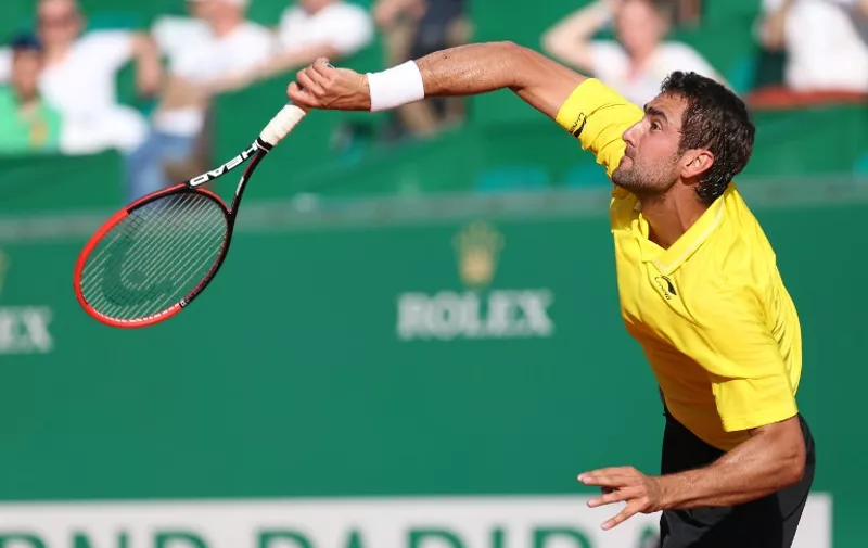 Croatian player Marin Cilic serves against German player Florian Mayer during the Monte-Carlo ATP Masters Series Tournament tennis match, on April 14, 2015 in Monaco. AFP PHOTO / JEAN-CHRISTOPHE MAGNENET