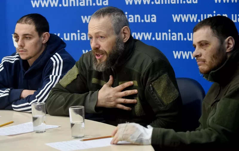 Russian prisoners of war, officers of the police (L-R) sergeant Yevgeniy Plotnikov, lieutenant colonel Dmitriy Astakhov, and captain Yevgeniy Spiridonov are presented to the press in Ukrainian capital of Kyiv on March 2, 2022. - Russia steps up its bombing campaign and missile strikes on Ukraine's cities on March 2, 2022. (Photo by Sergei SUPINSKY / AFP)