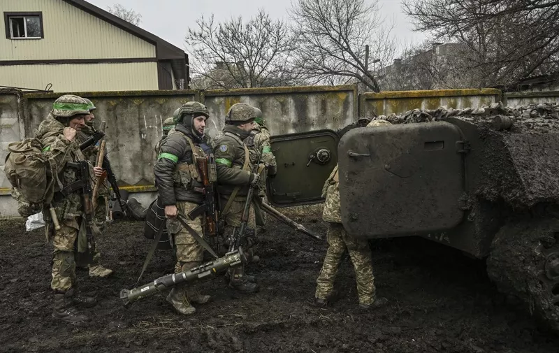 Ukrainian servicemen prepare to move towards the front line near the city of Bakhmut, on March 8, 2023, amid the Russian invasion of Ukraine. (Photo by Aris Messinis / AFP)