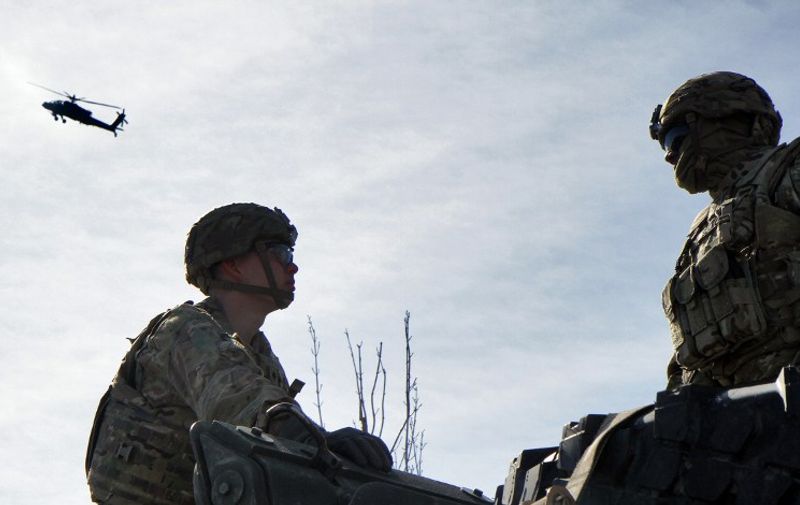 Soldiers of the US Army's 3rd Squadron, 2nd Cavalry Regiment arrive during the "Dragoon Ride" exercise in Vilnius on March 22, 2015. During the operation "Dragoon Ride", the ability to move manpower and heavy vehicles will be trained in the Baltic countries. AFP PHOTO / PETRAS MALUKAS / AFP PHOTO / PETRAS MALUKAS