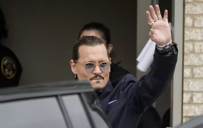 (FILES) In this file photo taken on May 27, 2022 US actor Johnny Depp waves to fans as he departs the Fairfax County Courthouse in Fairfax, Virginia. - A US jury found June 1, 2022 that actress Amber Heard had made defamatory claims of abuse against her ex-husband Johnny Depp, and awarded him $15 million in damages. (Photo by Drew Angerer / GETTY IMAGES NORTH AMERICA / AFP)