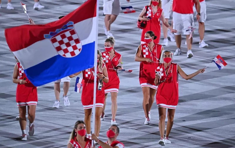 Croatia's flag bearer Sandra Perkovic (L) and Croatia's flag bearer Josip Glasnovic lead the delegation during the opening ceremony of the Tokyo 2020 Olympic Games, at the Olympic Stadium, in Tokyo, on July 23, 2021. (Photo by Ben STANSALL / AFP)