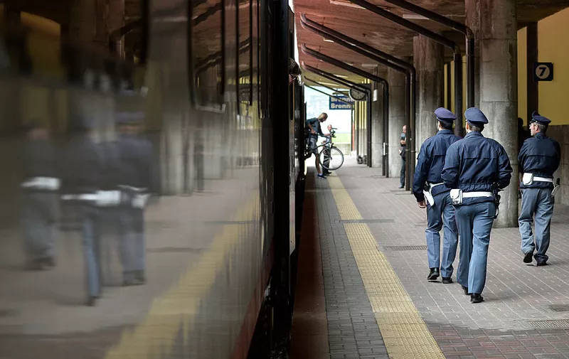 BRENNERO, ITALY - SEPTEMBER 03:  Italian police officers walk by a train bound north to Munich at the Brenner Pass on September 3, 2015 in Brennero, Italy. Italian police have announced they will soon reinstate border controls at the Brenner following a request from Germany in order to regulate the flow of migrants. Hundreds of migrants travel via trains and other means through the Brenner Pass daily, the vast majority on their way to Germany. (Photo by Philipp Guelland/Getty Images)
