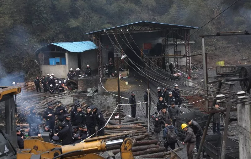 Chinese police and miners at the entrance to the mine near Leiyang city in central China's Hunan province on February 16, 2012, after fifteen miners died and another three were injured when a tramcar derailed in a coal mine in central China, in the latest accident to hit the dangerous industry.  Latest figures show that 2,433 people died in coal mining accidents in the country in 2010, according to official statistics -- a rate of more than six workers per day.      CHINA OUT      AFP PHOTO / AFP / STR