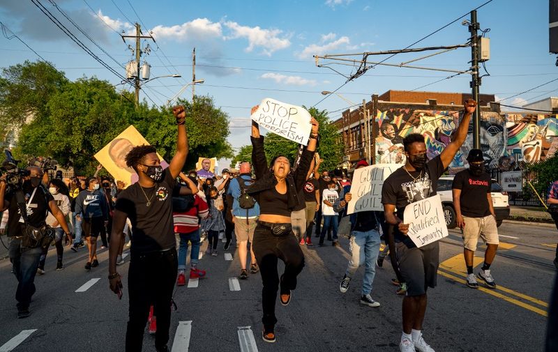 ATLANTA, GA - APRIL 20: Qri Montague (center) and others march through the streets after the verdict was announced for Derek Chauvin on April 20, 2021 in Atlanta, United States. Former police officer Derek Chauvin was on trial on second-degree murder, third-degree murder and second-degree manslaughter charges in the death of George Floyd May 25, 2020. After video was released of then-officer Chauvin kneeling on Floyd's neck for nine minutes and twenty-nine seconds, protests broke out across the U.S. and around the world. The jury found Chauvin guilty on all three charges.   Megan Varner/Getty Images/AFP (Photo by Megan Varner / GETTY IMAGES NORTH AMERICA / Getty Images via AFP)