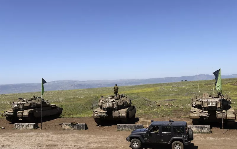 Israeli soldiers take part in a military exercise near Moshav Kidmat Tsvi in the Israeli-annexed Golan Heights on April 3, 2023. (Photo by JALAA MAREY / AFP)
