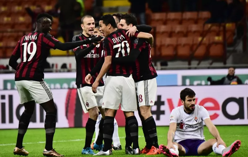 AC Milan's Colombian forward Carlos Bacca celebrates with teammates after scoring a goal during the Serie A football match between AC Milan and Fiorentina at the San Siro Stadium in Milan on January 17, 2016. / AFP / GIUSEPPE CACACE