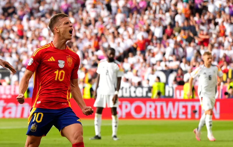 Spain's Dani Olmo celebrates after scoring his sides first goal during a quarter final match between Germany and Spain at the Euro 2024 soccer tournament in Stuttgart, Germany, Friday, July 5, 2024. (AP Photo/Manu Fernandez)