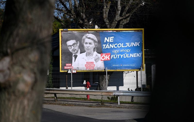 A new billboard showing European Commission President Ursula von der Leyen and Alexander Soros, son of Hungarian-US billionaire George Soros, with the lettering "Let's not dance to their tunes! National consultation", is pictured in Budapest, Hungary, on November 22, 2023. The Hungarian government on November 17, 2023 launched a "national consultation" billed as "protecting" the country against alleged European Union policies, including war-torn Ukraines potential membership of the bloc. Prime Minister Orban's nationalist government has, since 2015, frequently used such questionnaires, backed by extensive multimedia campaigns, to claim legitimacy for its positions and to attack EU policies. (Photo by ATTILA KISBENEDEK / AFP)