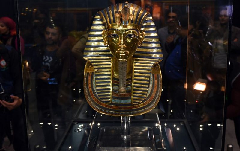 The golden mask of legendary Egyptian boy king Tutankhamun is displayed at the Egyptian Museum in Cairo after its restoration, on December 16, 2015. The restored mask -- now back in its display case at the museum -- was shown to journalists after a team of German experts worked on it for more than two months to remove a crust of dried glue from the beard of the priceless relic.   AFP  PHOTO / MOHAMED EL-SHAHED / AFP / MOHAMED EL-SHAHED