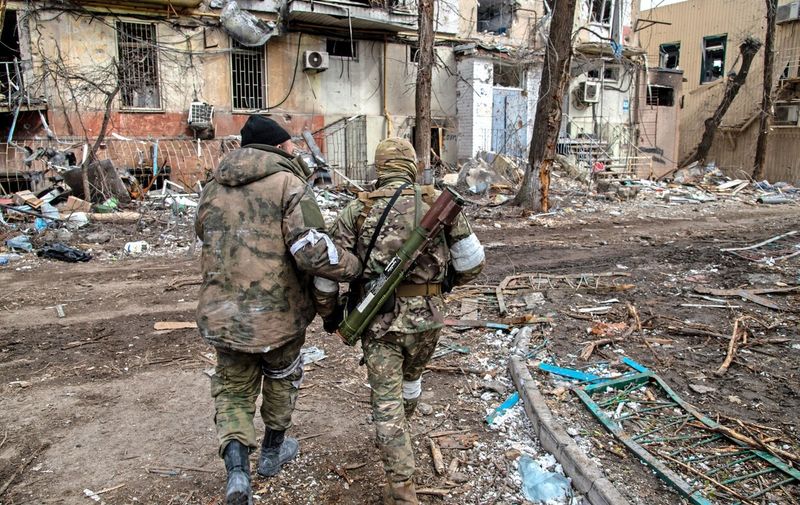 These images, taken by Maximilian Clarke, show images from within Donbas across the last few days, after severe fighting and heavy shelling between Russian and Ukrainian forces as Russia continues it's attempts an eastern offensive across the Donbas region. 
Pictured: Russian and Chechen soldiers in a devastated Mariupol neighbourhood close to the Azovstal frontline.
Donbas Offensive, Ukraine - 16 Apr 2022,Image: 684857847, License: Rights-managed, Restrictions: , Model Release: no, Credit line: Profimedia