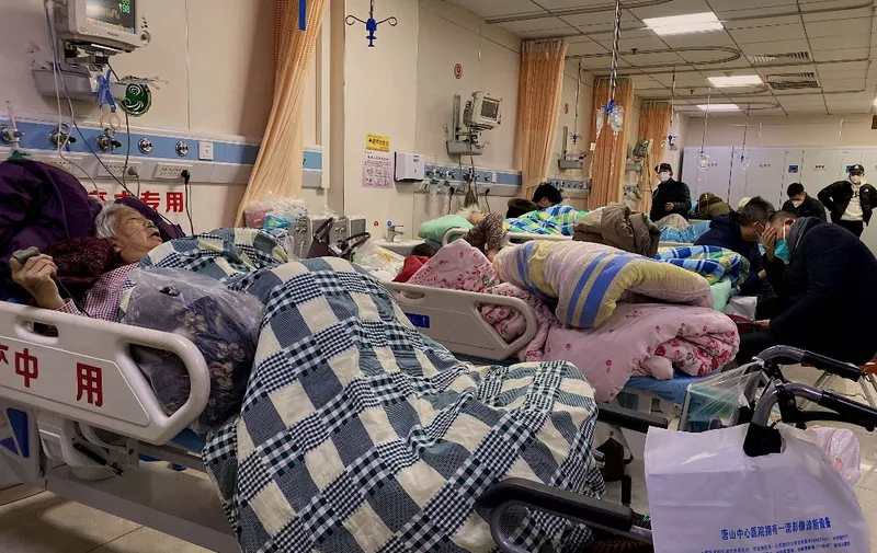 Patients with Covid-19 lay in beds at Tangshan Gongren Hospital in China's northeastern city of Tangshan on December 30, 2022. (Photo by Noel Celis / AFP)