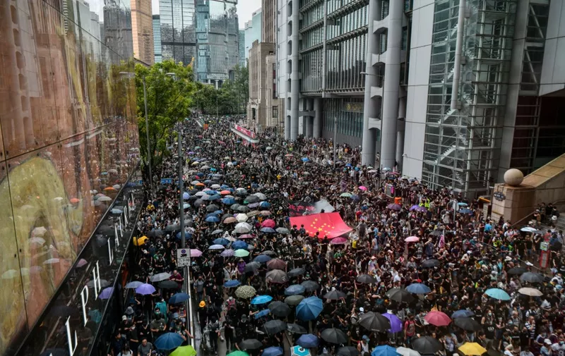 Protesters march in the Central district of Hong Kong on August 31, 2019. - Thousands of pro-democracy protesters defied a police ban on rallying in Hong Kong on August 31, a day after several leading activists and lawmakers were arrested in a sweeping crackdown. (Photo by Anthony WALLACE / AFP)