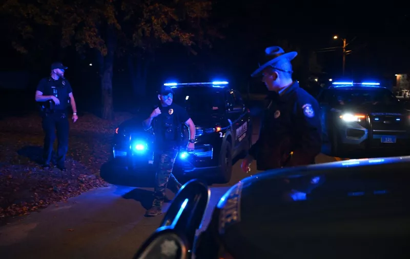 Police officers block traffic after suspect Robert Card was found dead in Lisbon, Maine, on October 27, 2023. The suspect in a mass shooting in the US state of Maine has been found dead of an apparent self-inflicted gunshot wound, US media reported October 27, after an intense manhunt that lasted more than two days.
Confirmed details were not immediately known, but authorities in Maine called a news conference for 10 pm (0200 GMT). (Photo by ANGELA WEISS / AFP)