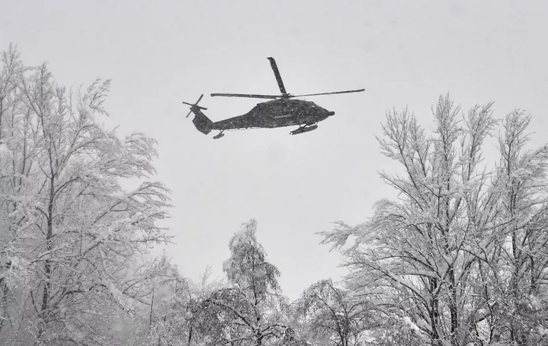 A military helicopter monitors the situation at the Austrian-German border at Kufstein after heavy snowfall in Austria on January 10, 2019. (Photo by JOE KLAMAR / AFP)