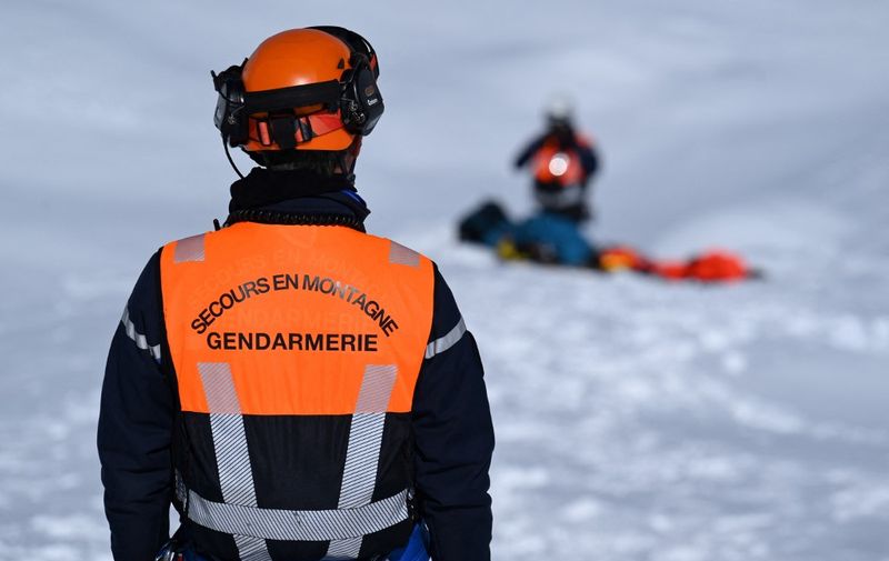 A gendarme of the French "Peloton de Gendarmerie de Haute Montagne" (High Mountain Police Squad, PGHM) takes part in an avalanche search and rescue training, near Briancon in the French Alps on March 16, 2023. (Photo by Nicolas TUCAT / AFP)