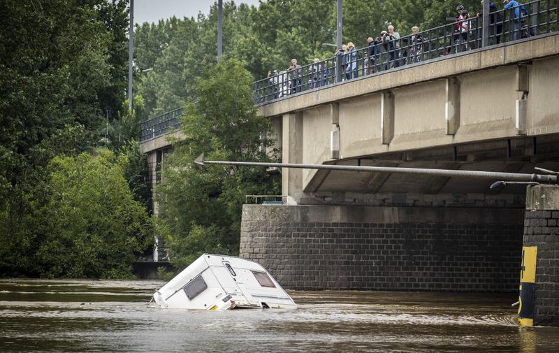 A caravan floats by in the high water of the Maas / Meuse river, in Roermond on July 16, 2021 after heavy rainfall of the previous days. - The death toll from devastating floods in Europe soared to at least 126 on July 16, 2021, most in western Germany where emergency responders were frantically searching for missing people. (Photo by Vincent Jannink / ANP / AFP) / Netherlands OUT