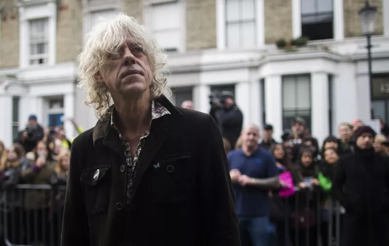 Irish musician Bob Geldof arrives at a west London studio to record the new Band Aid 30 single on November 15, 2014. Bob Geldof, One Direction, Bono and some 30 other stars gathered in a studio in London on Saturday to record a 30th anniversary version of the Band Aid charity single to raise money to fight Ebola. Led Zeppelin's Robert Plant, Coldplay's Chris Martin and Sinead O'Connor were also among the rockers brought together by Geldof to sing the fourth version of "Do They Know It's Christmas?" Musicians began arriving in the early morning and were expected to record all day and into the night before the single is aired for the first time on Sunday and then officially released on Monday. AFP PHOTO / ANDREW COWIE