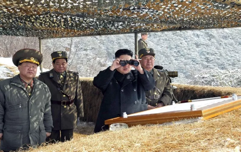 This picture taken by North Korea's official Korean Central News Agency on March 20, 2013 shows North Korean leader Kim Jong-Un (2nd R) using binoculars to inspect a live fire drill using self-propelled drones at an undisclosed location in North Korea. Kim oversaw the live fire military drill using drones and cruise missile interceptors, state media said on March 20, amid heightened tensions on the Korean peninsula. AFP PHOTO / KCNA via KNS
---EDITORS NOTE--- RESTRICTED TO EDITORIAL USE - MANDATORY CREDIT "AFP PHOTO / KCNA VIA KNS" - NO MARKETING NO ADVERTISING CAMPAIGNS - DISTRIBUTED AS A SERVICE TO CLIENTS / AFP / KCNA / KNS