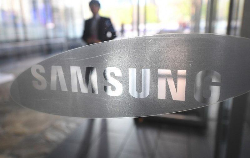 (FILES) This file photo taken on October 26, 2016 shows a man walking past the logo of Samsung Electronics at a flagship store in Seoul.
Samsung's $8 billion offer for Harman International drove up shares in the auto electronics maker sharply while major US equities markets were little-changed early November 14, 2016. About a half-hour into trading, the Dow Jones Industrial average was up 0.3 percent at 18,904.23, building on last week's record close on the back of a post-election rally. The broader S&amp;P 500 was flat at 2,164.76 
 / AFP PHOTO / JUNG YEON-JE