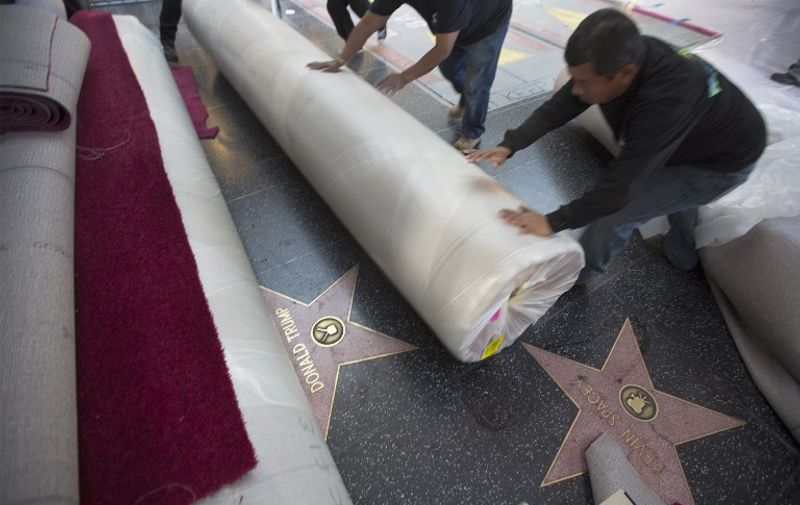 HOLLYWOOD, CA - FEBRUARY 25: Workers piling rolls of red carpet cover the Hollywood Walk of Fame star for entertainer and presidential candidate Donald Trump near the red carpet arrivals area on Hollywood Boulevard for the 88th Annual Academy Awards at Hollywood &amp; Highland Center on February 25, 2016 in Hollywood, California.   David McNew/Getty Images/AFP