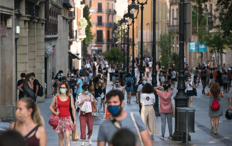 BARCELONA, SPAIN - JULY 27: People walk along Portal de l'Angel on July 27, 2020 in Barcelona, Spain. Spanish officials insisted it was still safe to travel to the country despite a recent rise in coronavirus (COVID-19) cases, which led the UK government to reimpose a 14-day quarantine on arrivals from Spain. The Catalonian government had recently issued a stay-at-home recommendation that included the regional capital, Barcelona. (Photo by Cesc Maymo/Getty Images)