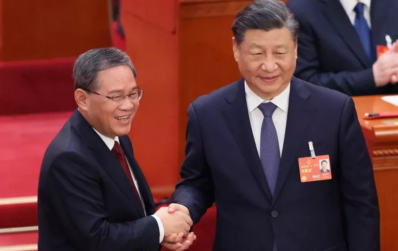 FILE: Chinese President Xi Jinping shakes hands with Li Qiang (L), China's premier, during the National People's Congress in Beijing on March 11, 2023. President Xi turns 70 years old on June 15th. Xi Jinping has entered his third term as the general secretary of the Chinese Communist Party (CCP) and president of the People's Republic of China (PRC) to strengthen the leadership.( The Yomiuri Shimbun ) (Photo by Ichiro Ohara / Yomiuri / The Yomiuri Shimbun via AFP)