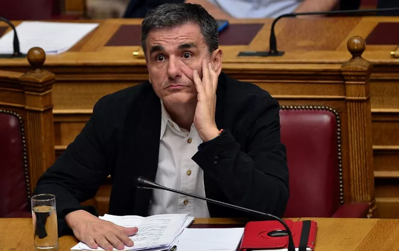 Greek Finance minister Euclid Tsakalotos attends a session at the Greek parliament in Athens on July 22, 2015. Prime Minister Alexis Tsipras faced a new test of his authority in parliament on July 22, where MPs were to vote on a second batch of reforms to help unlock a bailout for Greece's stricken economy. The embattled premier last week faced a revolt by a fifth of the lawmakers in his radical-left Syriza party over changes to taxes, pensions and labour rules demanded by EU-IMF creditors. AFP PHOTO/ LOUISA GOULIAMAKI