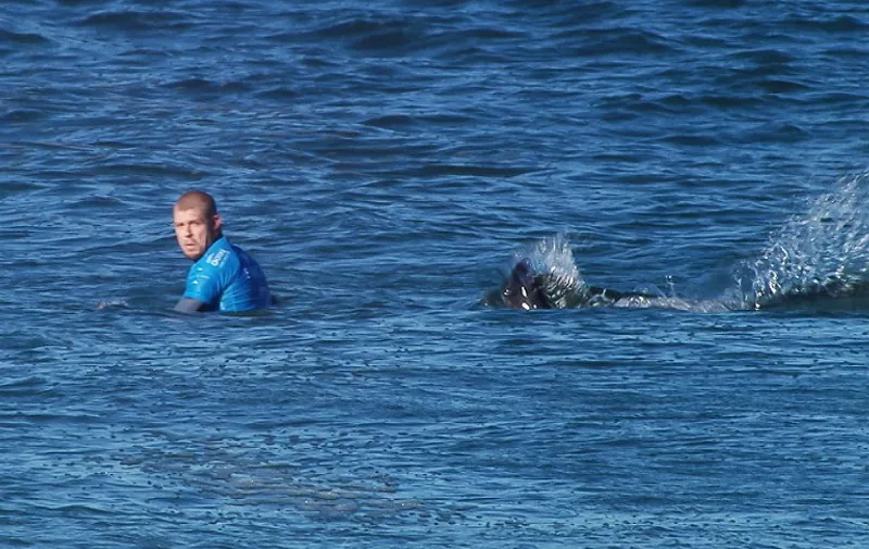 This handout screengrab made and released on July 19, 2015 by the Worl Surf League (WSL) shows Australian surfer Mick Fanning shortly before being attacked by a shark during the Final of the JBay surf Open on Sunday July 19, 2015 in Jeffreys Bay. Mick Fanning, 34, was competing in the final heat of a world tour event at Jeffreys Bay in the country's Eastern Cape province when a looming black fin appeared in the water behind him. He fought back against the shark, escaping from the terrifying scene without injury.    AFP PHOTO / WSL
==RESTRICTED TO EDITORIAL USE - MANDATORY CREDIT "AFP PHOTO / WSL" - NO MARKETING - NO ADVERTISING CAMPAIGNS - DISTRIBUTED AS A SERVICE TO CLIENTS==