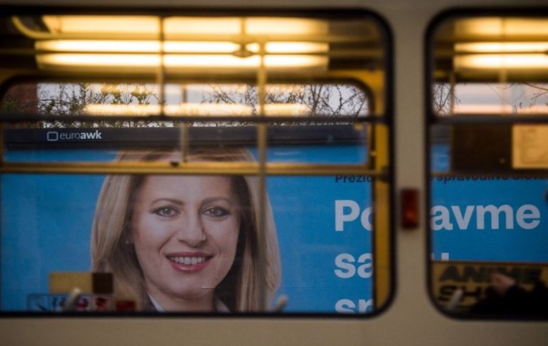 A picture taken on March 29, 2019 in Bratislava shows a billboard bearing a portrait of presidential candidate Zuzana Caputova and reading "Stand up against evil, together we can do it". - Zuzana Caputova, a Slovak government critic who will face off against the ruling party's candidate in the second round of presidential elections, is a liberal lawyer hoping to become the EU member's first female head of state. (Photo by VLADIMIR SIMICEK / AFP)
