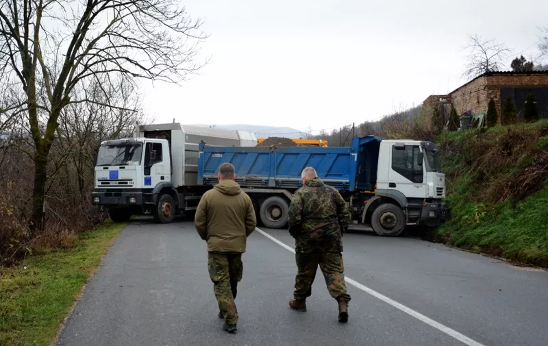 German officers serving in the peacekeeping mission in Kosovo (KFOR) inspect a road barricade set up with trucks by ethnic Serbs in the village of Rudare near the town of Zvecan on December 12, 2022. - Tensions were high in northern Kosovo on Sunday after unknown attackers exchanged gunfire with the police and threw a stun grenade at EU law enforcers during the night.
Hundreds of Serbs, outraged over the arrest of a former police officer, gathered again early in the morning at the roadblocks erected Saturday and which have paralysed traffic through two border crossings from Kosovo to Serbia. (Photo by STRINGER / AFP)