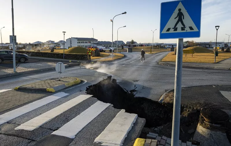 This photo taken on November 13, 2023 shows a crack cutting across the main road in Grindavik, southwestern Iceland following earthquakes. The southwestern town of Grindavik -- home to around 4,000 people -- was evacuated in the early hours of November 11 after magma shifting under the Earth's crust caused hundreds of earthquakes in what experts warned could be a precursor to a volcanic eruption.  The seismic activity damaged roads and buildings in the town situated 40 kilometres (25 miles) southwest of the capital Reykjavik, an AFP journalist saw. (Photo by Kjartan TORBJOERNSSON / AFP) / Iceland OUT