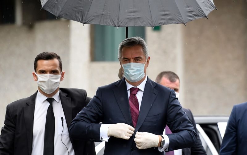 Montenegro's President Milo Djukanovic (C) arrives for a meeting at the Medical center in capital Podgorica, on March 27, 2020, amid the outbreak of COVID-19, caused by the coronavirus.  Montenegro, which has detected 70 confirmed infections of COVID-19 so far, issued strict measures, including a closure of schools, ban on public gatherings, and restrictions of land and sea passenger transport.,Image: 510135138, License: Rights-managed, Restrictions: , Model Release: no