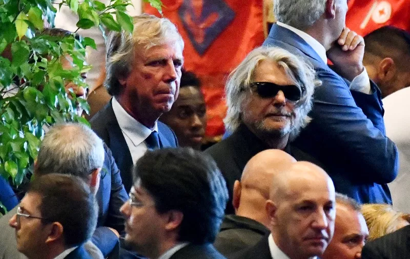 Italian chairman of the Italian Serie A football club Genoa Enrico Preziosi (L) and Italian chairman for the football team Sampdoria Massimo Ferrero (R) attend the mass of the funeral service for the victims of the collapsed Morandi highway bridge, in Genoa, on August 18, 2018. - Fury is growing over the shock collapse of the Morandi bridge, a decades-old viaduct that crumbled in a storm on August 14 killing at least 38 people, with Italian media reporting that some outraged families would shun August 19's official commemorations. (Photo by Andrea LEONI / AFP)