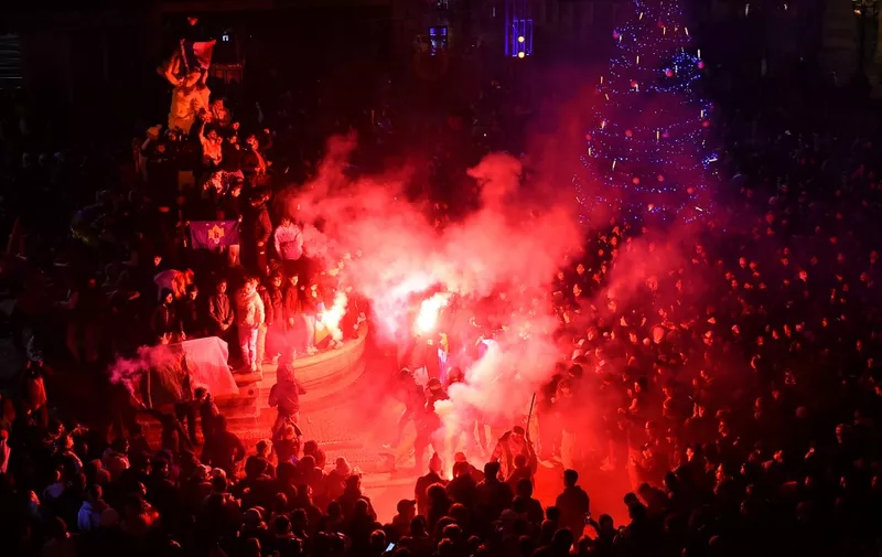 French supporters light flares as they celebrate their team's victory over England in the Qatar 2022 World Cup quarter-final football match in Montpellier on December 10, 2022. (Photo by Sylvain THOMAS / AFP)