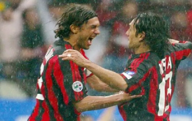 AC Milan's captain Paolo Maldini (L) jubilates with his teammate Alessandro Nesta at the end of their Italian Serie A football match against AS Roma in Milan's San Siro stadium, 02 May 2004. AC Milan won the match 1-0 and the Italian championship.  AFP PHOTO/ Patrick HERTZOG