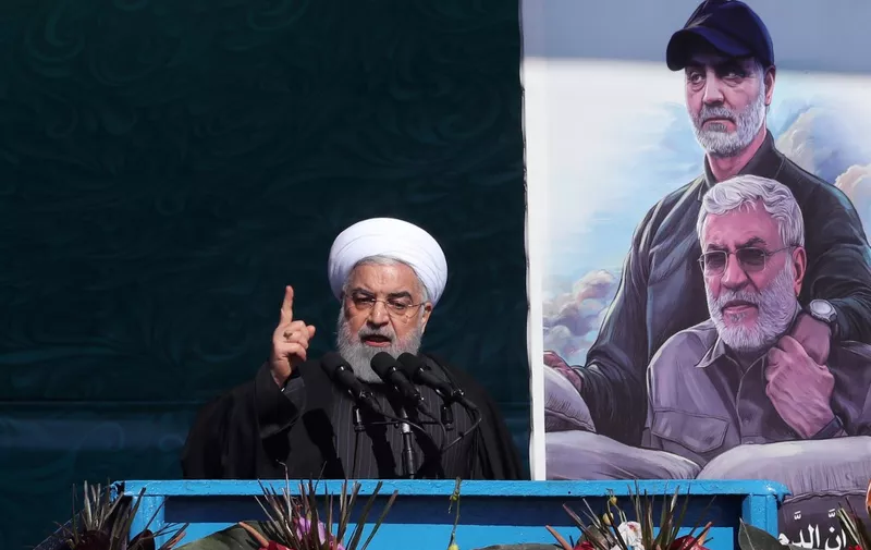 A handout picture provided by the Iranian presidency on February 11, 2020, shows President Hassan Rouhani delivering a speech, next to portraits of Iran's late top general Qasem Soleimani and Iraqi paramilitary commander Abu Mahdi al-Muhandis in a US drone strike near Baghdad airport last month, during commemorations marking 41 years since the Islamic Revolution in the capital Tehran's Azadi Square. - Thousands of Iranians massed for commemorations marking 41 years since the Islamic Revolution, in a show of unity at a time of heightened tensions with the United States. Waving flags of Iran and holding portraits of the founder of the Islamic republic, the late Ayatollah Ruhollah Khomeini, they converged on Tehran's Azadi Square despite chilly temperatures. (Photo by - / Iranian Presidency / AFP) / === RESTRICTED TO EDITORIAL USE - MANDATORY CREDIT "AFP PHOTO / HO / IRANIAN PRESIDENCY" - NO MARKETING NO ADVERTISING CAMPAIGNS - DISTRIBUTED AS A SERVICE TO CLIENTS ===