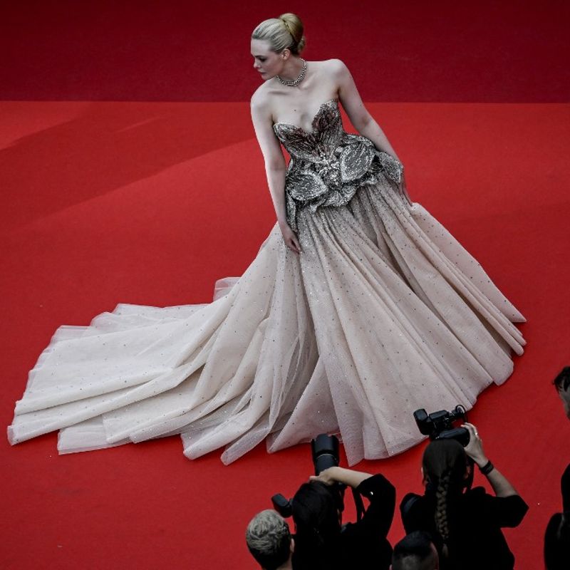 US actress Elle Fanning arrives for the opening ceremony and the screening of the film "Jeanne du Barry" during the 76th edition of the Cannes Film Festival in Cannes, southern France, on May 16, 2023. (Photo by Patricia Moreira / AFP)